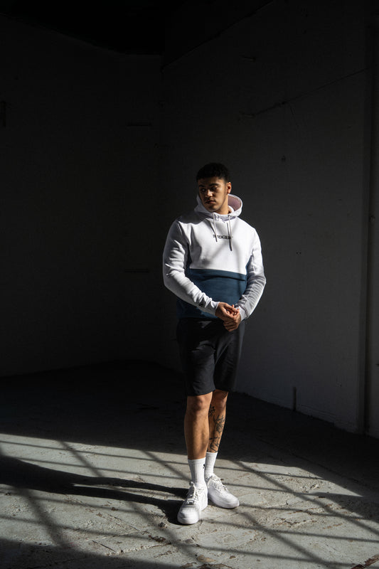 Streetwear block colour hoodie in white / Azure teal. Contrast branding on chest & logo on sleeve.